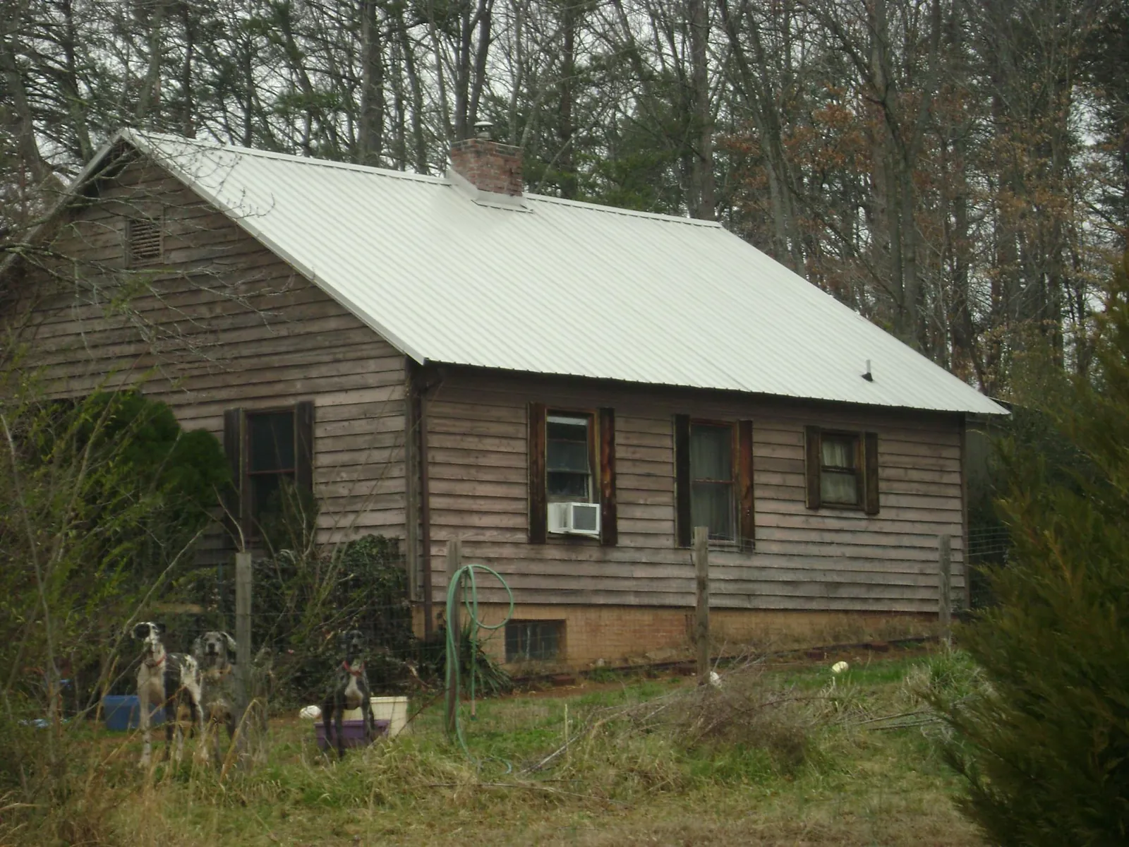 White metal roof on an old wood sided farmhouse, from a Metal Roof Installation job in Aneta